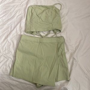 Two piece set. Crop top shirt with very cute tie back, bottom skort.